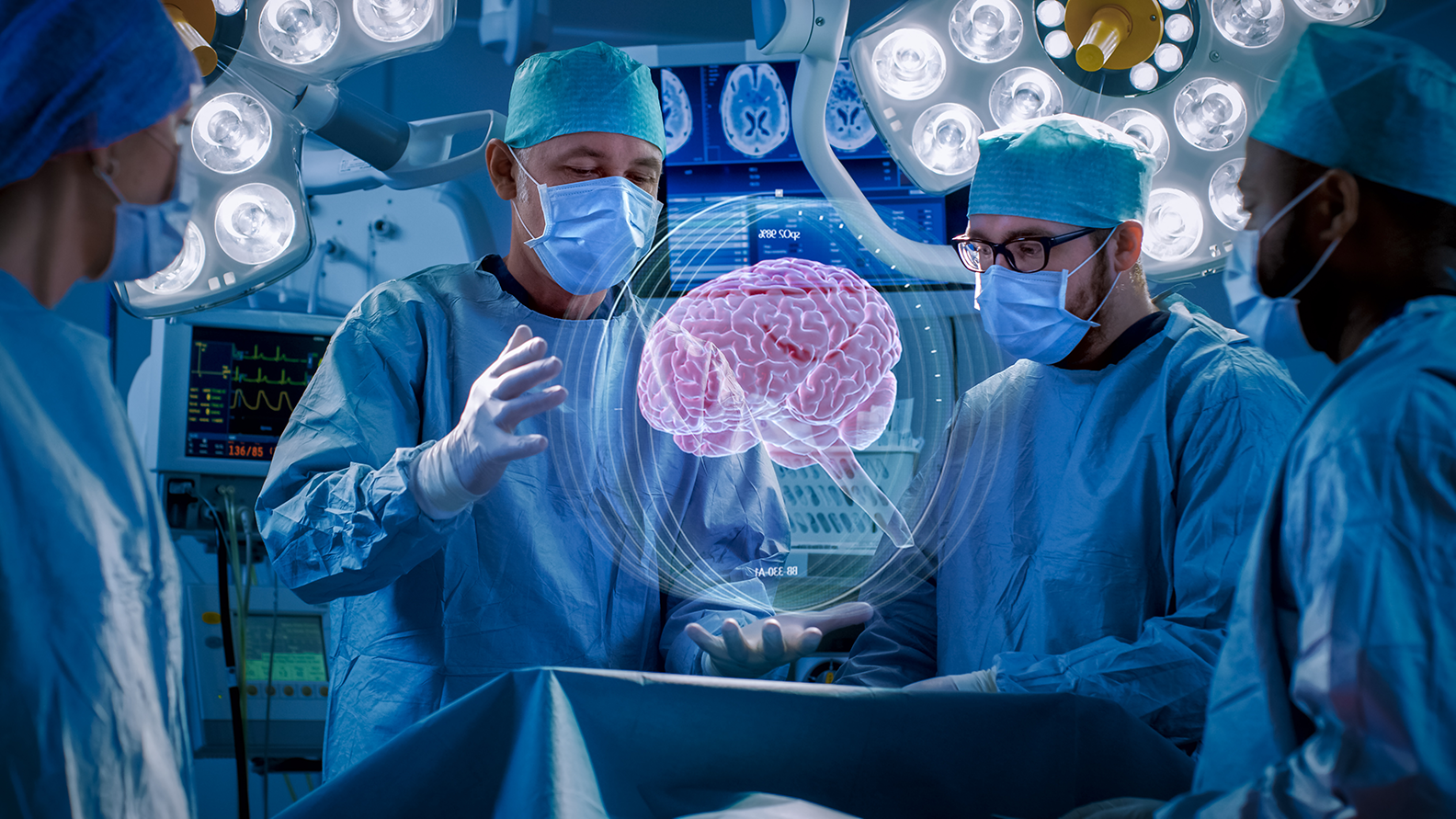Surgeons look at a digital hologram scan of a brain before they help a patient