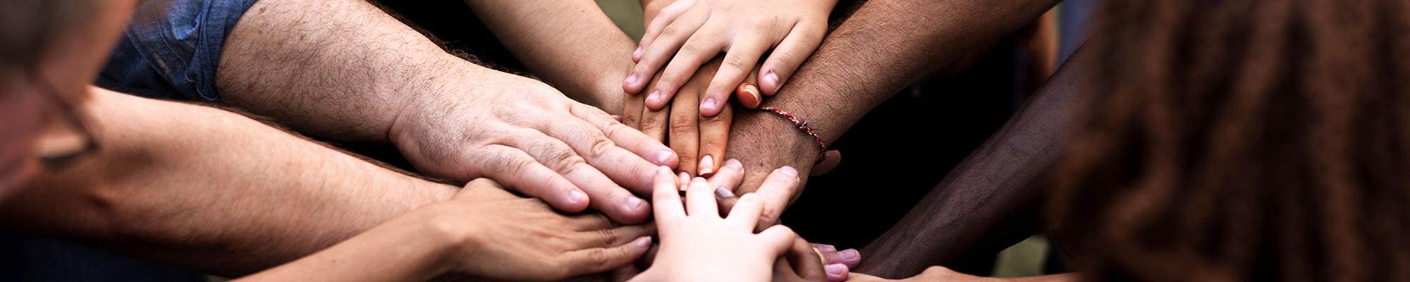 diverse hands clasped together