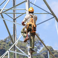 cable worker climbing a cell phone tower
